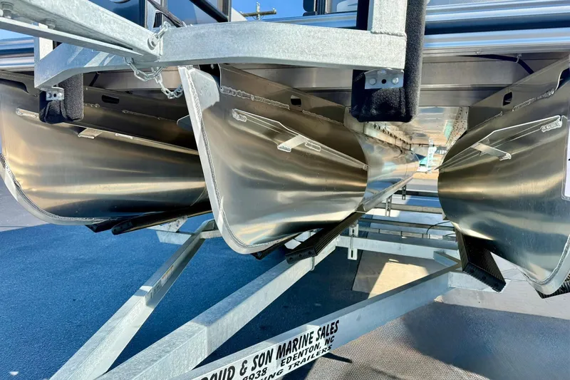 Slide: The Image of 2026 Crest Conquest 235 SLSC pontoon boat underside on trailer. - 16