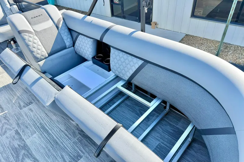 Slide: The Image of 2026 Crest Conquest 235 SLSC boat interior with gray seating and storage compartments. - 19