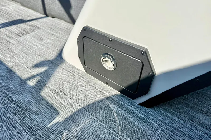 Slide: The Image of 2026 Crest Conquest 235 SLSC boat detail with sleek flooring and storage compartment. - 24