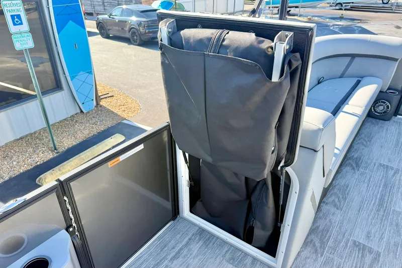 Slide: The Image of 2026 Crest Conquest 235 SLSC boat interior with storage compartment and seating. - 29