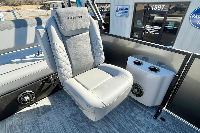 Slide: The Image of 2026 Crest Conquest 235 SLSC boat seat with cup holders and speaker. - 31