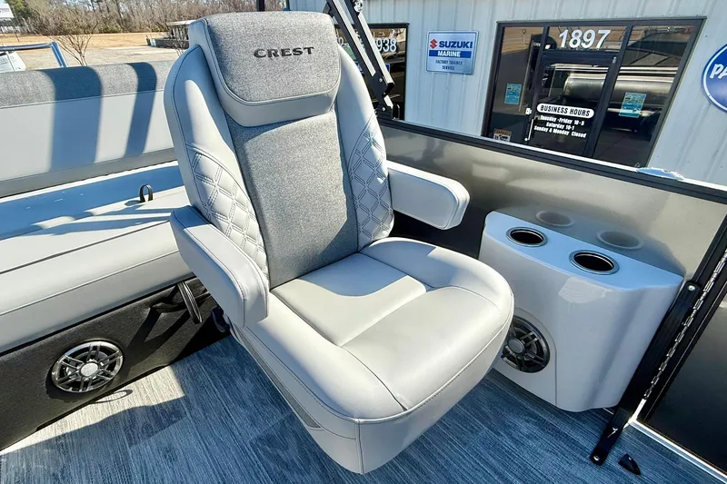 Slide: The Image of 2026 Crest Conquest 235 SLSC boat seat with armrests and cup holders. - 32