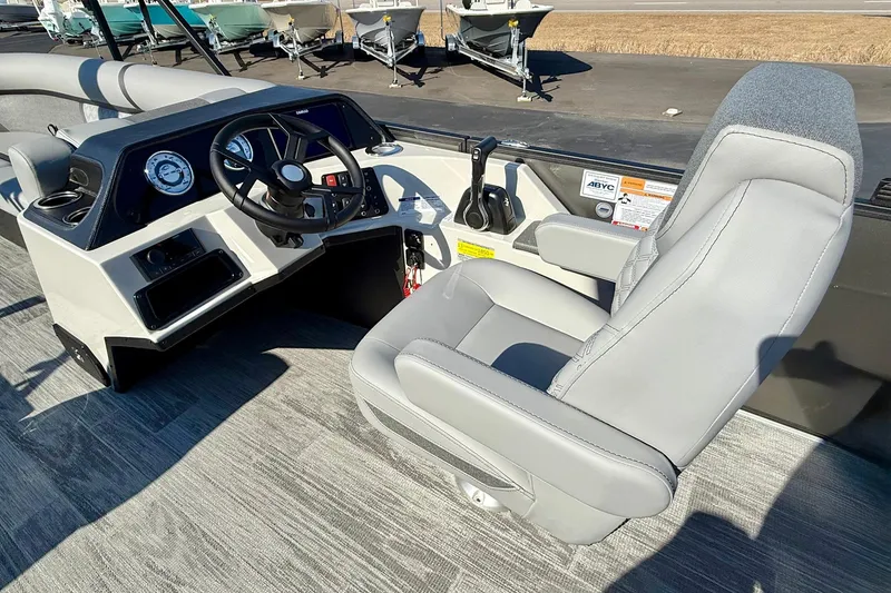 Slide: The Image of 2026 Crest Conquest 235 SLSC boat interior with steering wheel and captain's chair. - 34
