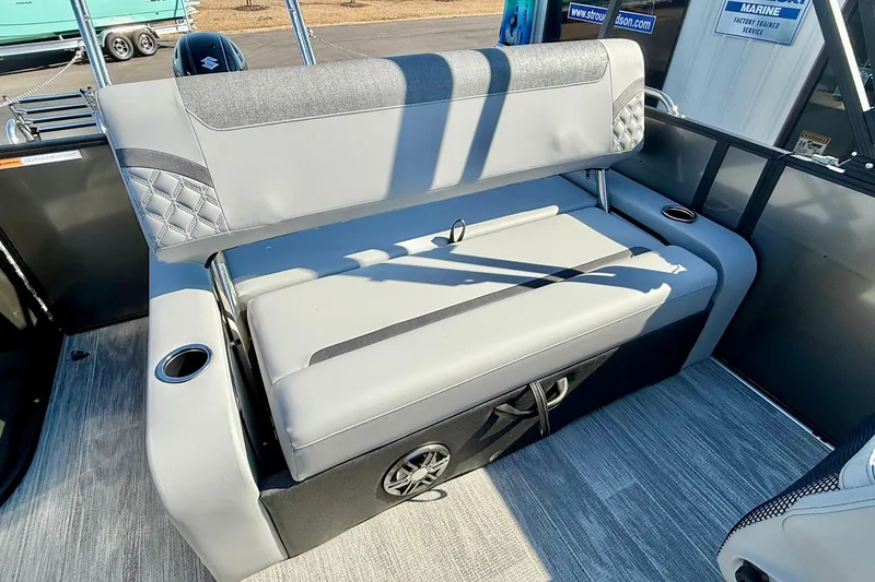 Slide: The Image of 2026 Crest Conquest 235 SLSC boat interior with gray cushioned seating and cup holders. - 42