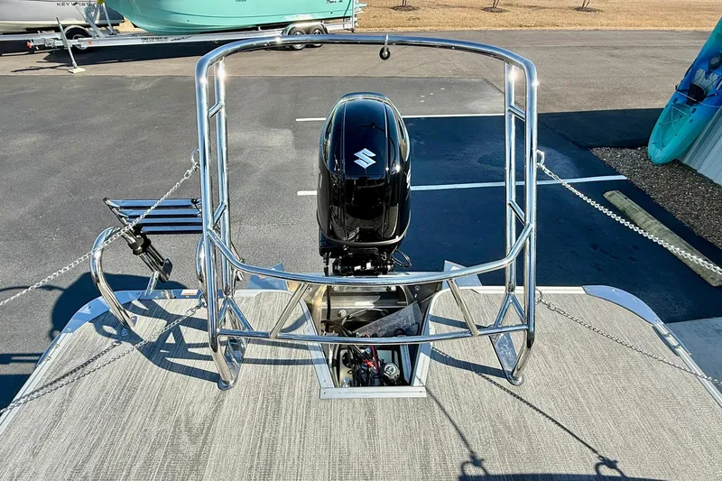 Slide: The Image of 2026 Crest Conquest 235 SLSC boat with Suzuki outboard motor, parked on asphalt. - 54