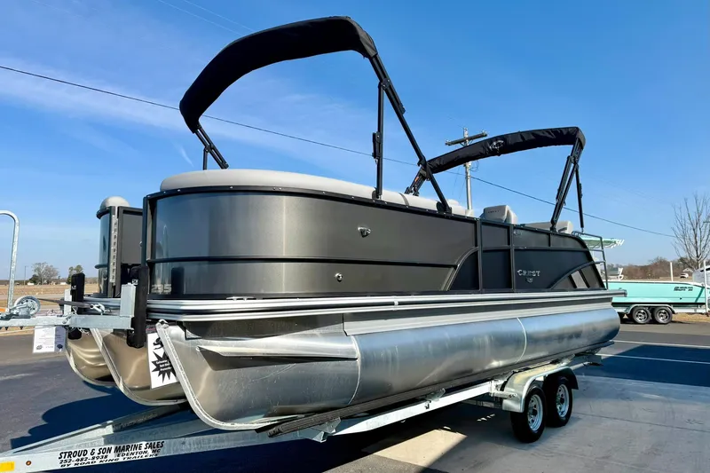 Slide: The Image of 2026 Crest Conquest 235 SLSC pontoon boat on trailer, sunny day. - 11