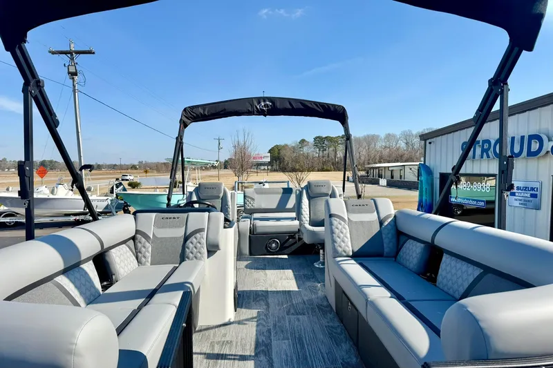 Slide: The Image of 2026 Crest Conquest 235 SLSC pontoon boat with luxurious seating and canopy. - 17