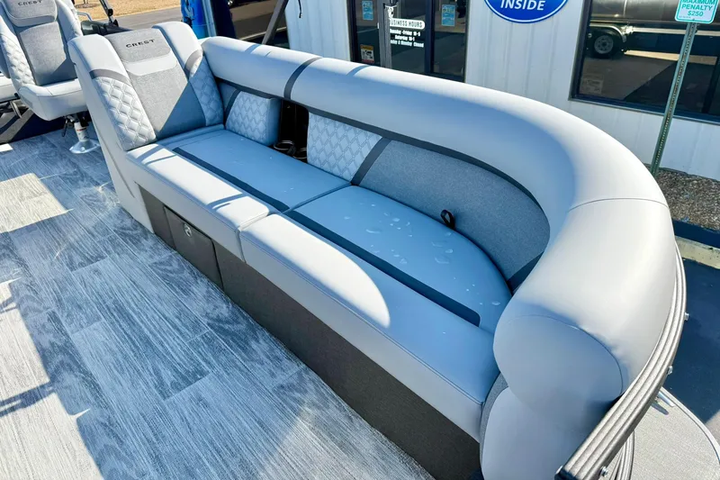 Slide: The Image of 2026 Crest Conquest 235 SLSC boat interior with luxurious gray seating. - 18