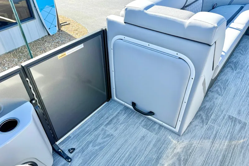 Slide: The Image of 2026 Crest Conquest 235 SLSC boat interior with seating and storage compartment. - 28