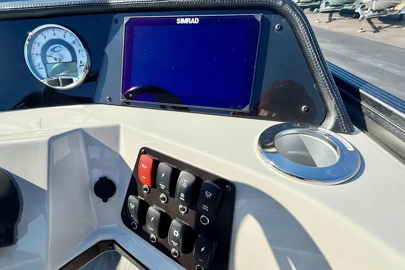 Slide: The Image of Dashboard of 2026 Crest Conquest 235 SLSC with Simrad display and controls. - 39