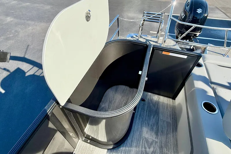 Slide: The Image of 2026 Crest Conquest 235 SLSC boat storage compartment with open hatch, showcasing interior space. - 53