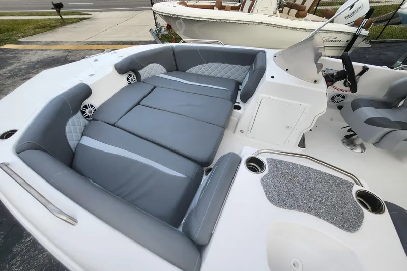 Slide: The Image of 2026 NauticStar 203 SC boat interior with gray seating and modern dashboard. - 11