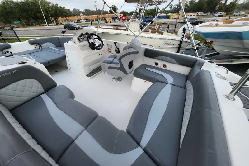 Slide: The Image of 2026 NauticStar 203 SC boat interior with gray seating and modern dashboard. - 5