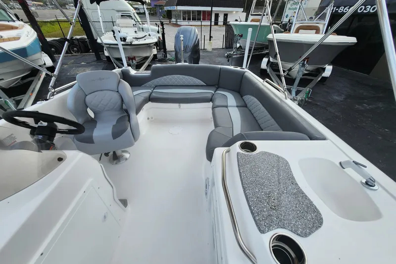 Slide: The Image of 2026 NauticStar 203 SC boat interior with gray seating and steering wheel. - 6
