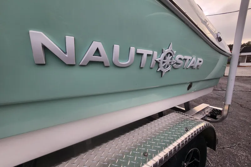 Slide: The Image of 2026 NauticStar 203 SC boat side view with logo, on a trailer. - 8