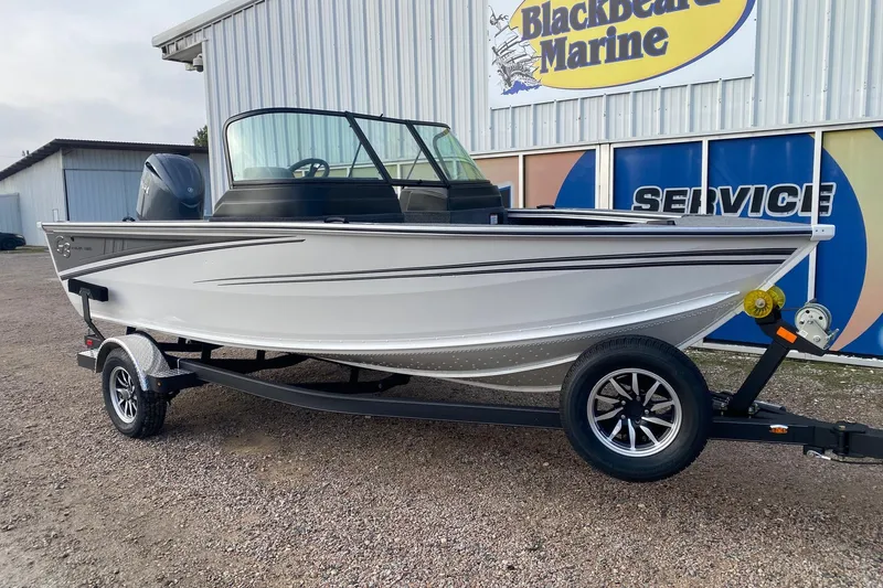 Slide: The Image of 2026 G3 Angler V1850 SF boat on trailer outside Blackbeard Marine service center. - 2