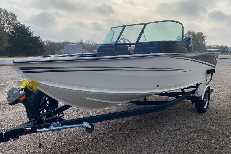 Slide: The Image of 2026 G3 Angler V1850 SF boat on trailer, parked outdoors. - 3