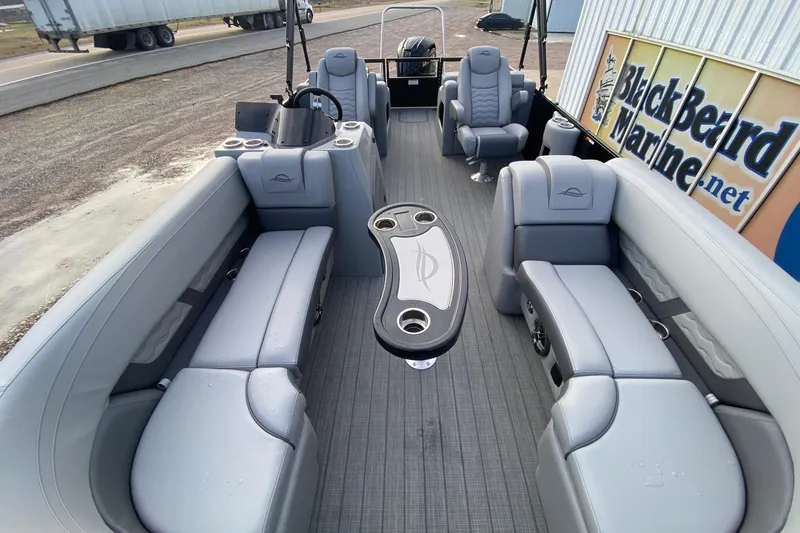 Slide: The Image of 2026 SunCatcher Fusion 322SS pontoon boat interior with gray seating and central table. - 6