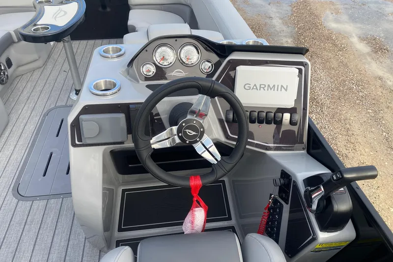 Slide: The Image of 2026 SunCatcher Fusion 322SS boat dashboard with Garmin navigation system and steering wheel. - 11
