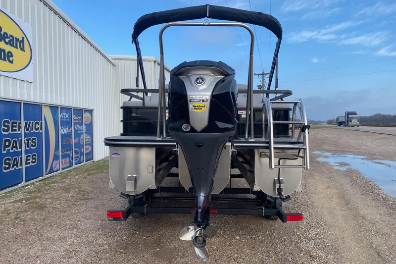 Slide: The Image of 2026 SunCatcher Fusion 322SS pontoon boat with Yamaha 250 engine, parked outside dealership. - 5