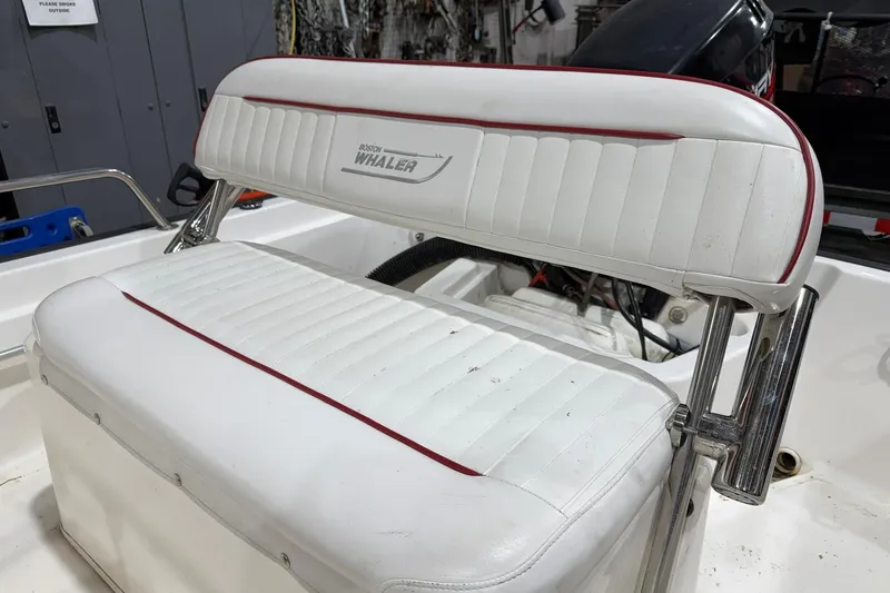 Slide: The Image of 1998 Boston Whaler Dauntless 13 boat seat with white and red upholstery. - 6