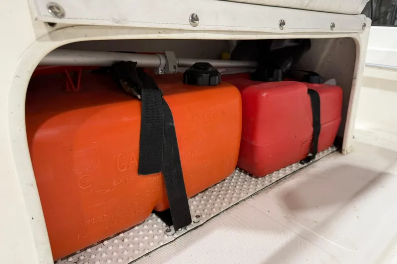 Slide: The Image of Fuel tanks secured in a 1998 Boston Whaler Dauntless 13 boat storage compartment. - 8