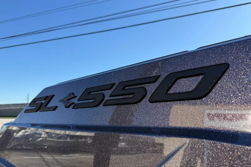 Slide: The Image of 2026 Supra SL 550 badge on metallic car exterior under clear blue sky. - 10
