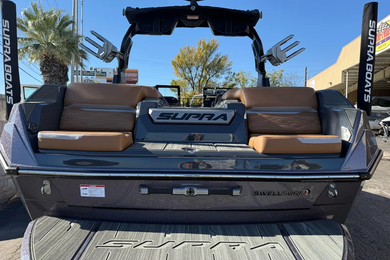 Slide: The Image of 2026 Supra SL 550 boat with luxurious seating and sleek design at a marina. - 15