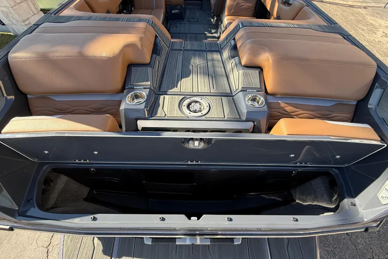 Slide: The Image of 2026 Supra SL 550 interior with tan leather seats and open storage compartment. - 17