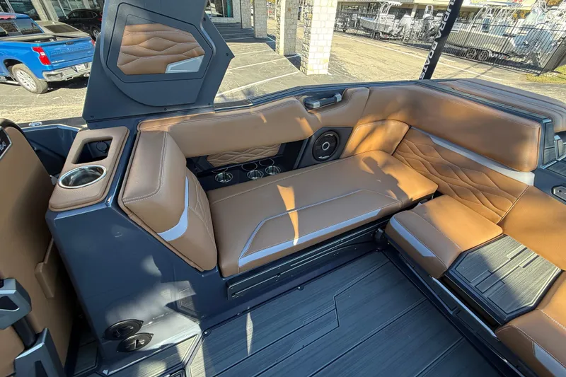Slide: The Image of 2026 Supra SL 550 boat interior with tan leather seating and cup holders. - 24