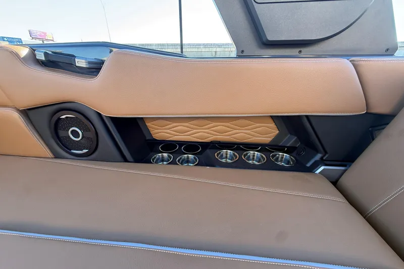 Slide: The Image of 2026 Supra SL 550 interior with brown leather, cup holders, and speaker detail. - 28