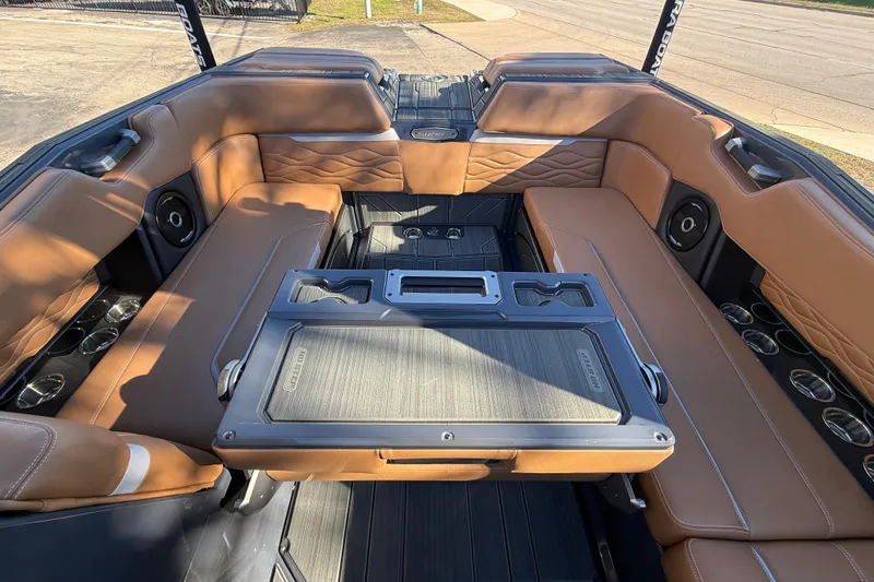 Slide: The Image of 2026 Supra SL 550 boat interior with luxurious brown seating and integrated speakers. - 32
