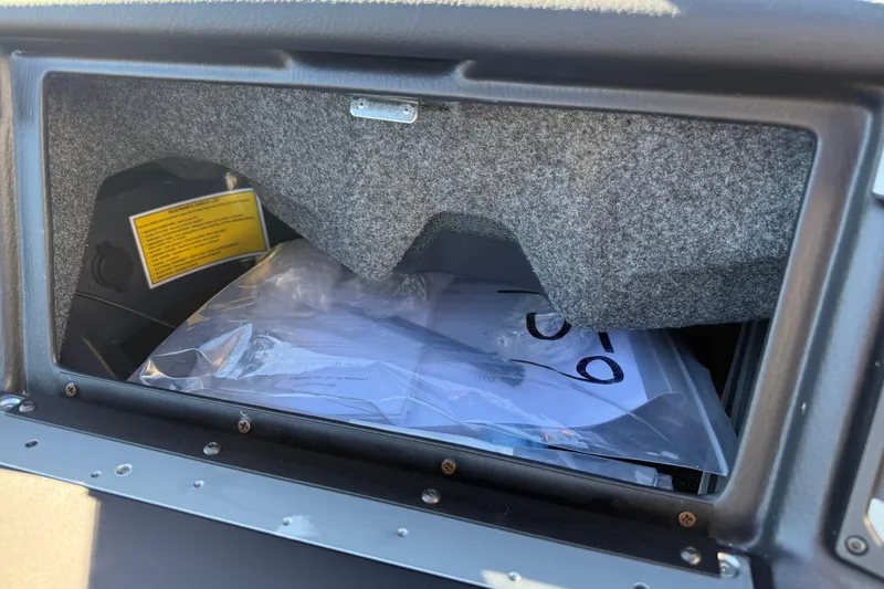 Slide: The Image of 2026 Supra SL 550 glove compartment with documents and manual inside. - 38