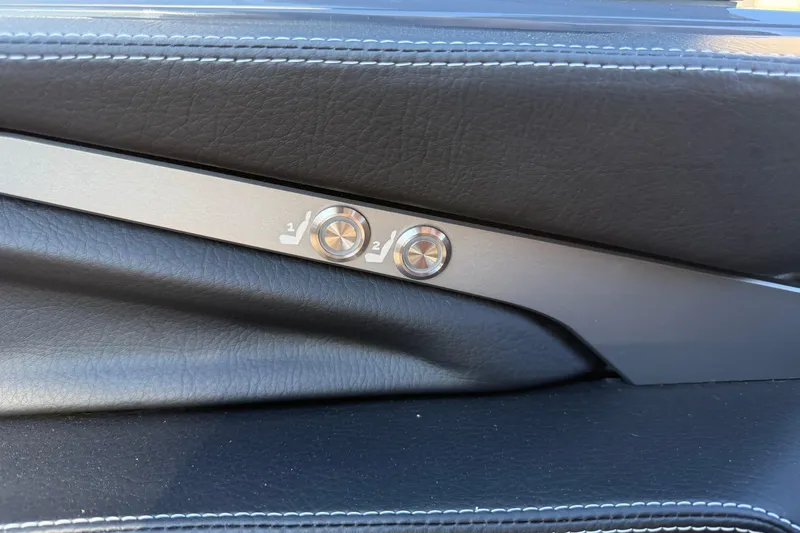 Slide: The Image of 2026 Supra SL 550 interior door panel with seat adjustment buttons. - 44