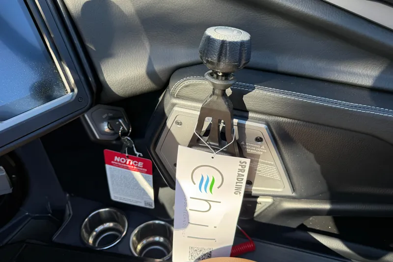 Slide: The Image of 2026 Supra SL 550 interior with gear shift, ignition key, and cup holders. - 45