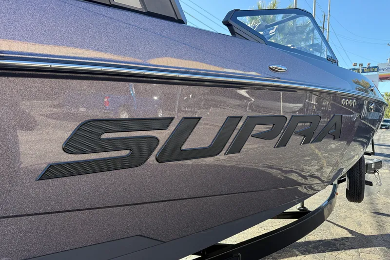Slide: The Image of 2026 Supra SL 550 boat with sleek design and bold branding. - 9