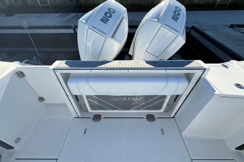 Slide: The Image of 2022 Blackfin 252 CC boat with dual Mercury 200 engines at dock. - 11
