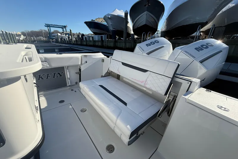 Slide: The Image of 2022 Blackfin 252 CC boat with white seating and dual outboard engines. - 12