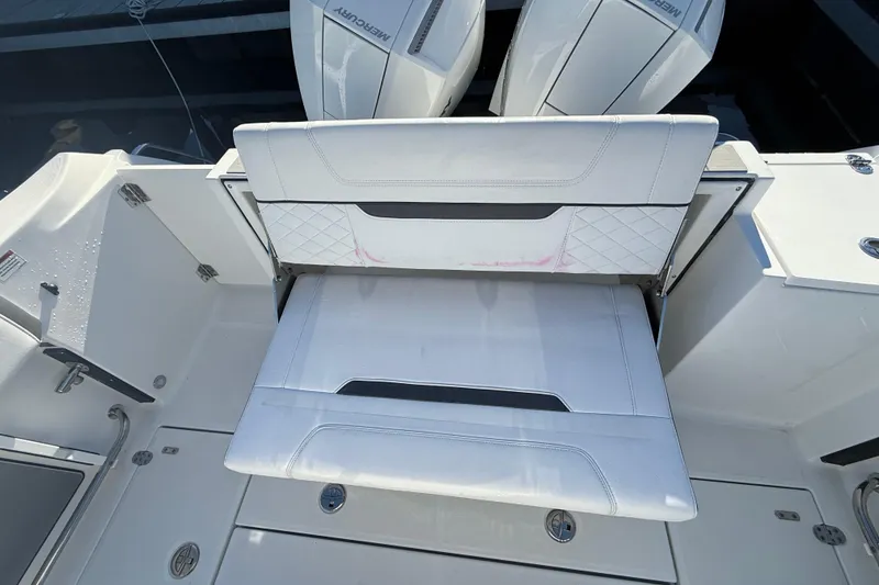 Slide: The Image of 2022 Blackfin 252 CC boat with white seating and Mercury engines. - 13