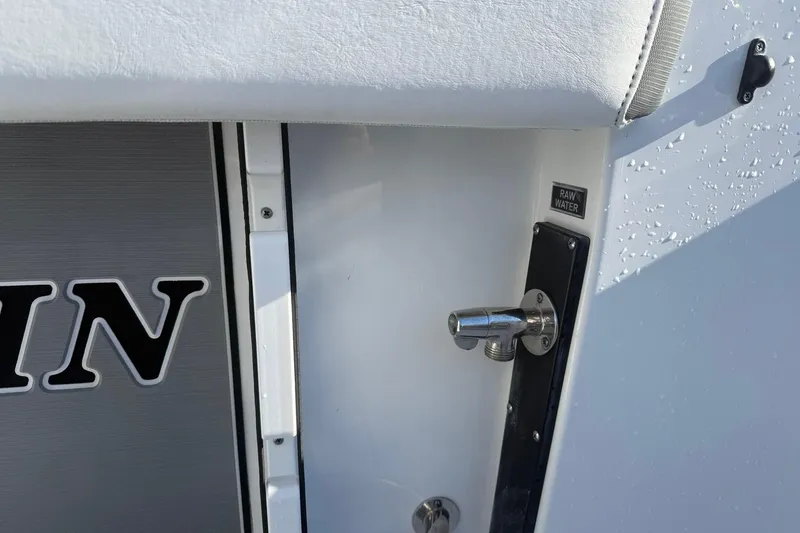 Slide: The Image of 2022 Blackfin 252 CC boat detail with raw water outlet and logo. - 14