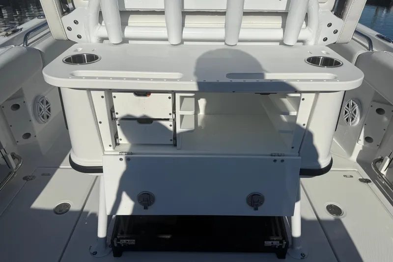 Slide: The Image of 2022 Blackfin 252 CC boat interior with storage compartments and cup holders. - 16