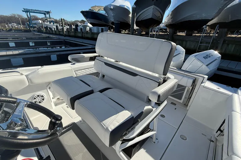 Slide: The Image of 2022 Blackfin 252 CC boat interior with white seating and steering wheel. - 22