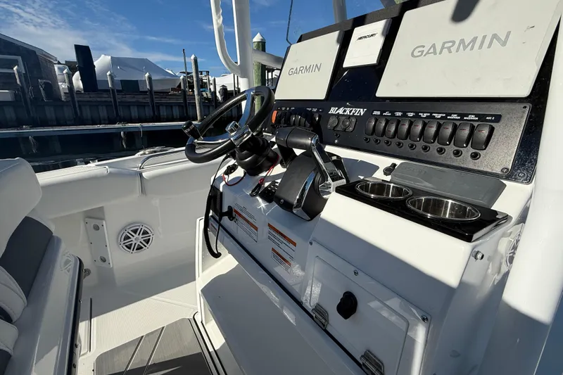 Slide: The Image of 2022 Blackfin 252 CC boat dashboard with Garmin displays and control panel. - 23