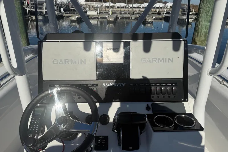 Slide: The Image of 2022 Blackfin 252 CC boat dashboard with Garmin displays at marina. - 24