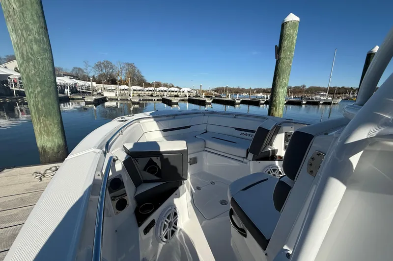 Slide: The Image of 2022 Blackfin 252 CC boat docked at marina under clear blue sky. - 30
