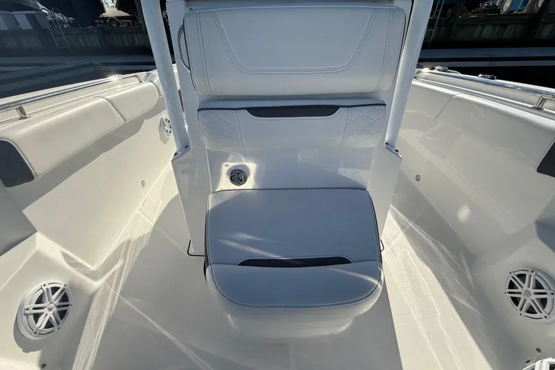 Slide: The Image of 2022 Blackfin 252 CC boat interior with white seating and speakers. - 34