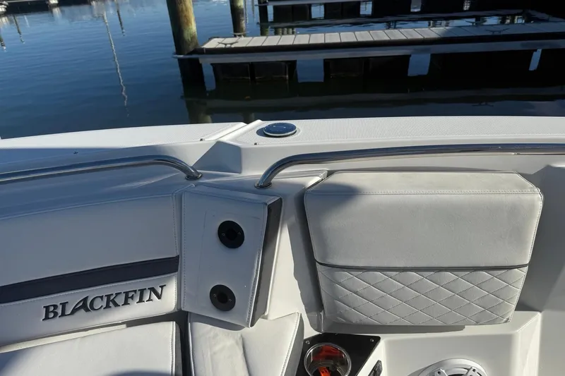 Slide: The Image of 2022 Blackfin 252 CC boat interior with sleek seating and dock view. - 36
