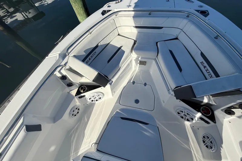 Slide: The Image of 2022 Blackfin 252 CC boat interior with cushioned seating and speakers. - 37