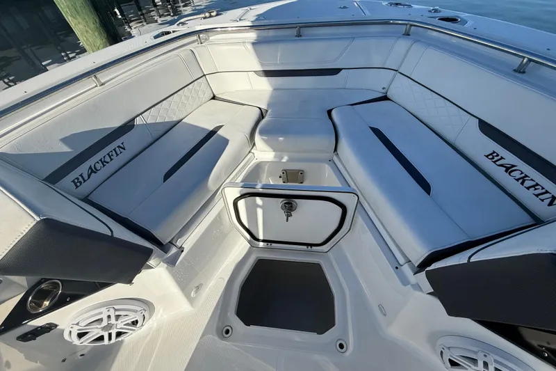 Slide: The Image of 2022 Blackfin 252 CC boat interior with cushioned seating and storage compartment. - 38