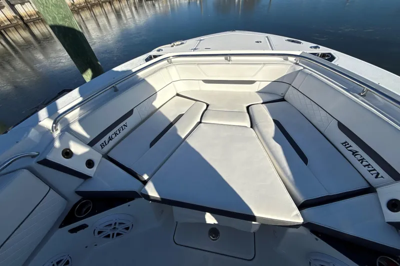 Slide: The Image of 2022 Blackfin 252 CC boat interior with white cushioned seating and sleek design. - 42